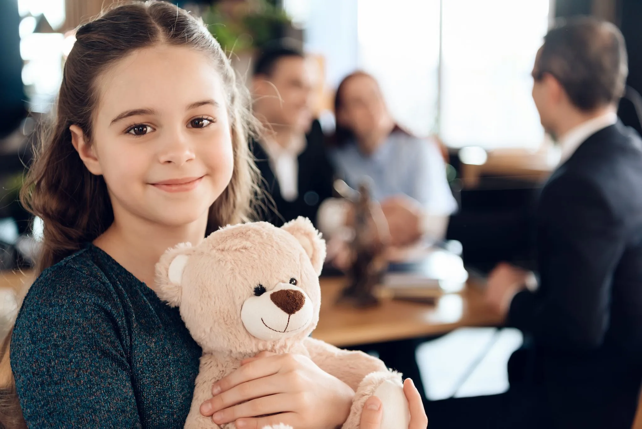 a girl holding a teddy bear